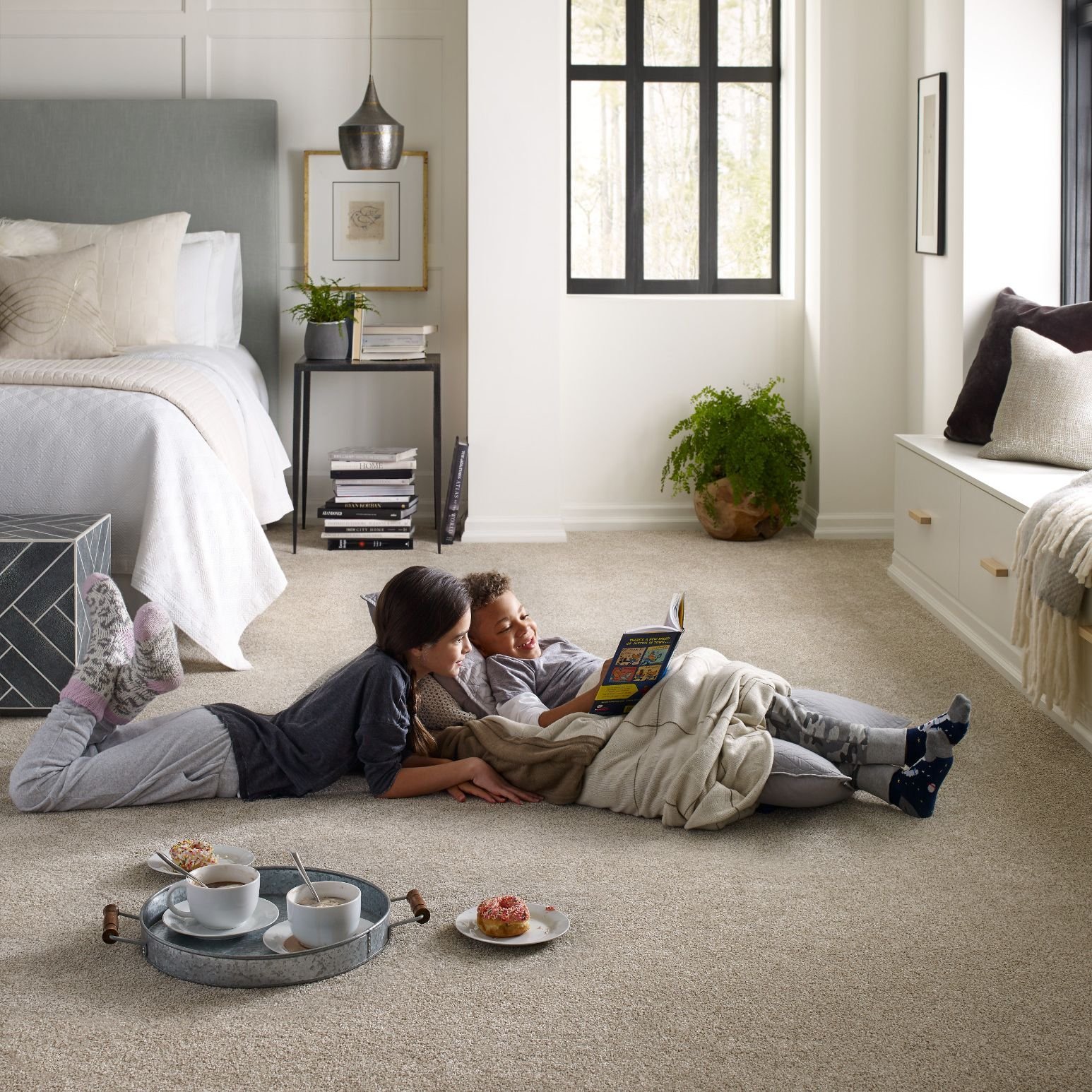 Two People Sitting on A Carpeted Floor from Farrior's Flooring in Wallace