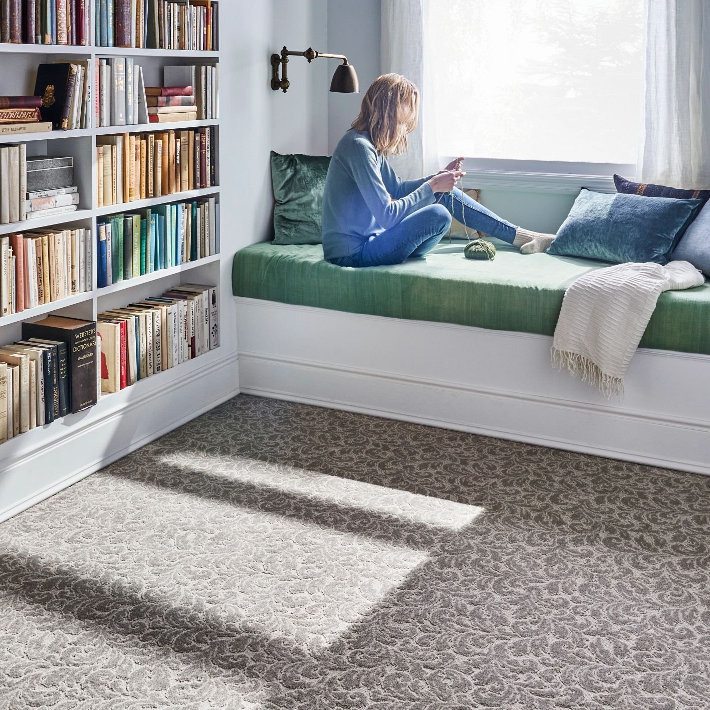 Woman sitting on a reading nook bed from Farrior's Flooring in Wallace