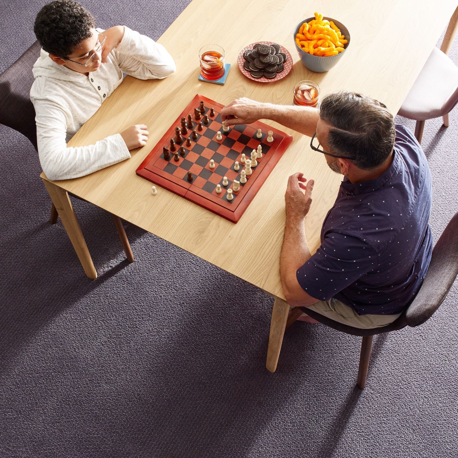 Before Your Floor Arrives: Pair of people playing chess at a table from Farrior's Flooring in Wallace