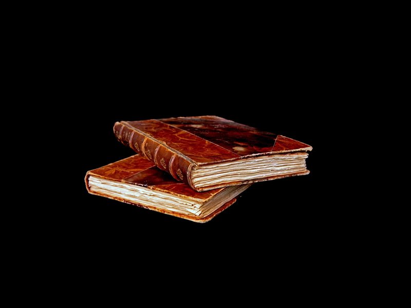 Stacked Books On Black Background from Farrior's Flooring in Wallace, NC